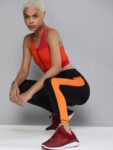 c50359c7-58a7-4e1b-bdae-bc4176afb55f1647948367129-HRX-by-Hrithik-Roshan-Women-Black–Orange-Solid-Running-Tigh-2